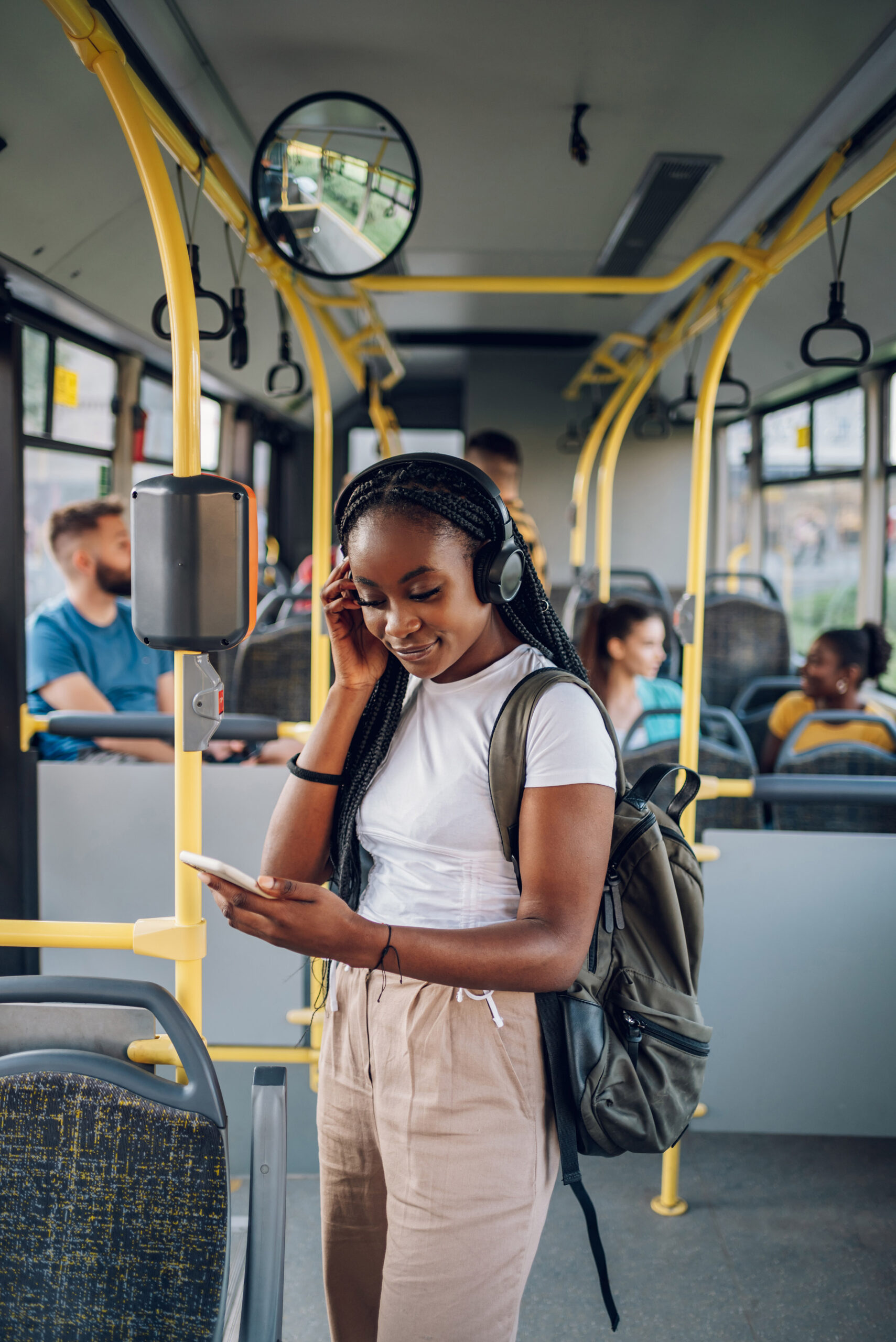 African american woman using smartphone while riding a bus